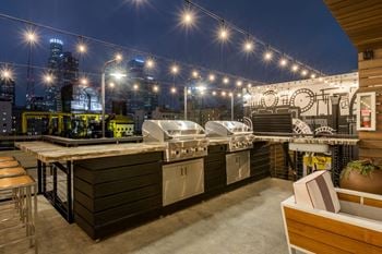 Contemporary roof deck with fireside lounge areas, led tv and gas grills